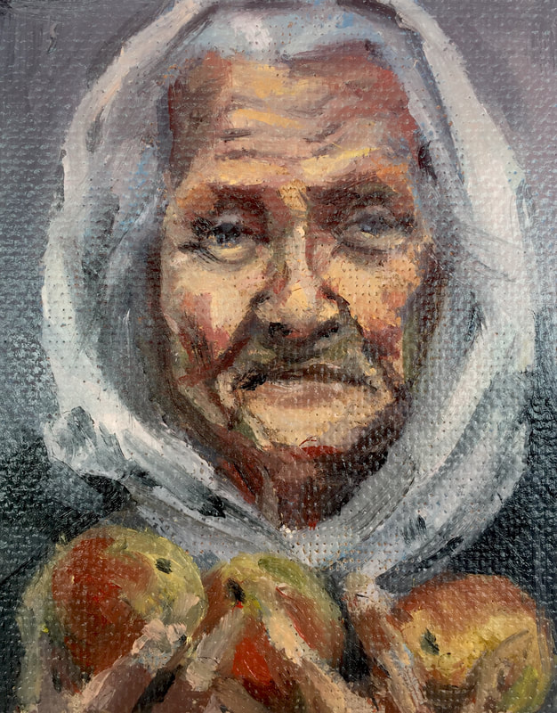 Old Ukrainian woman wearing headscarf, holding 3 apples in hands.